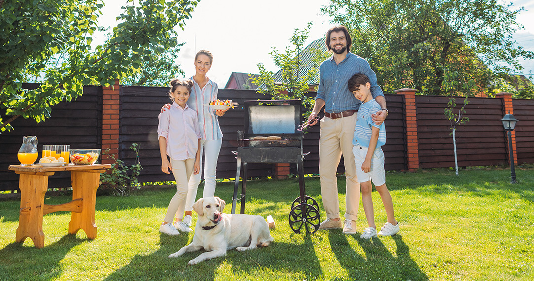 Family with Dog Having Barbecue Together Backyard Summer Day
