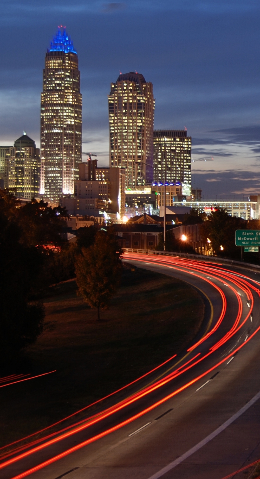 Charlotte skyline at night with traffic below