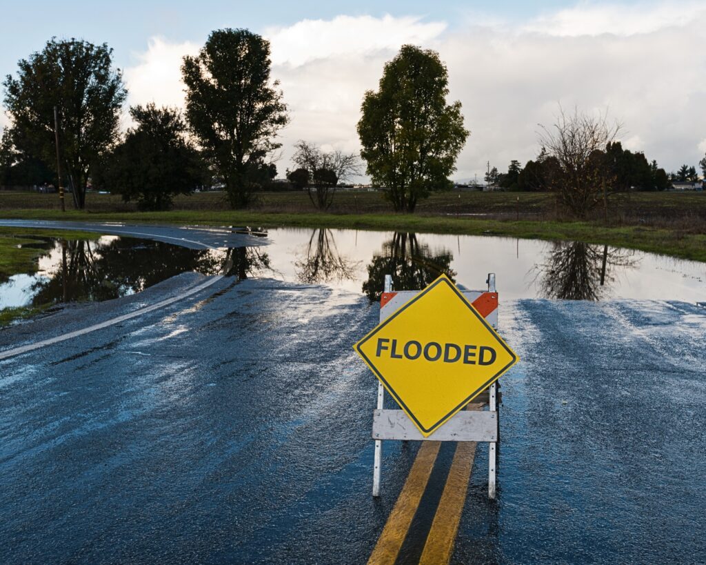 Flooding sign in middle of road