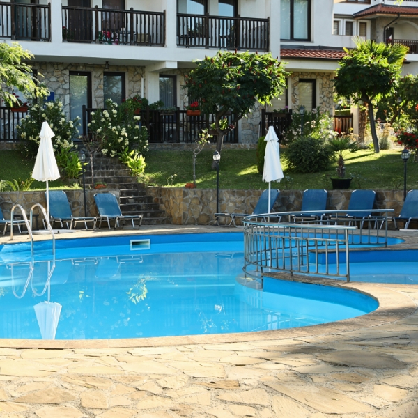 Hotel Pool area with trees and bushes around