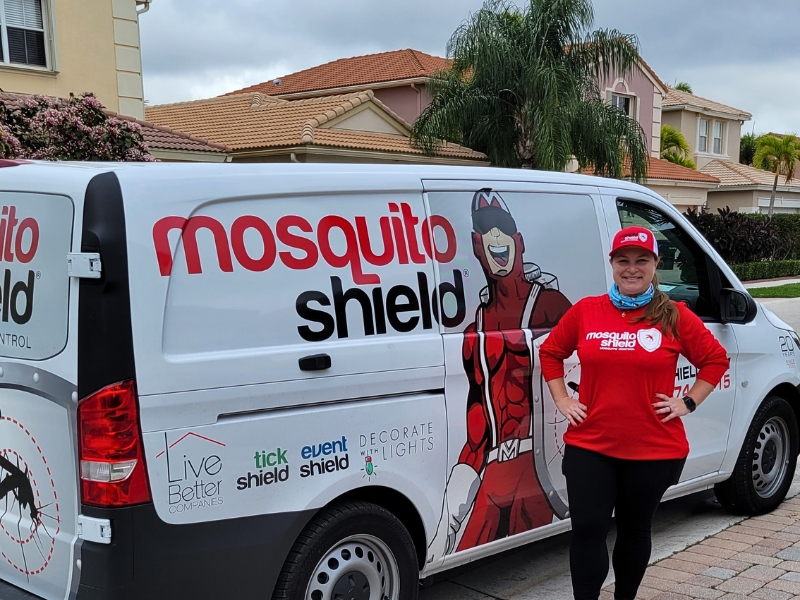 Technician in front of van Mosquito Shield of The Palm Beaches